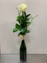 Single white rose in recycled bottle